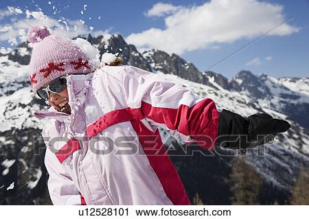 Girl in pink hit by snowball. View Large Photo Image Stock Image - Girl in pink hit by snowball.. Fotosearch