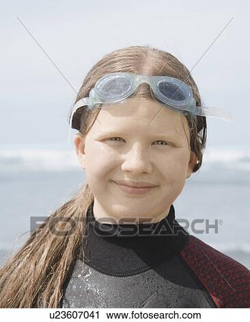 Stock Image - Girl in wet suit with goggles. Fotosearch