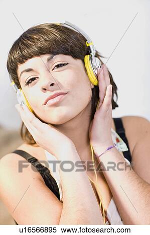 Girl listening to music with headphones View Large Photo Image Stock Photography - Girl listening to music with headphones. Fotosearch