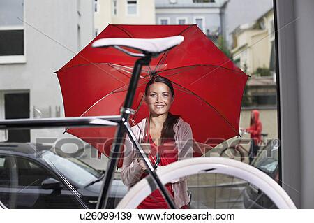 Stock Photo - girl looking in a bike store. Fotosearch