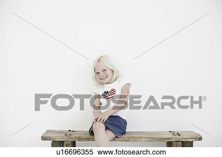 Girl on bench smiling to camera View Large Photo Image Stock Photography - Girl on bench smiling to camera. Fotosearch