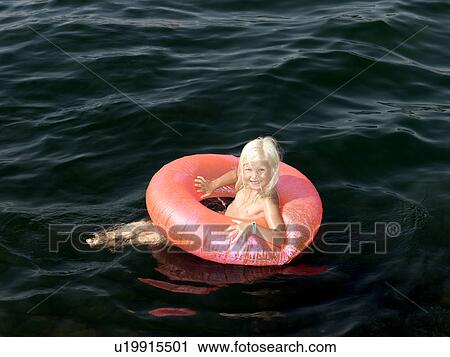 Girl on inflatable ring View Large Photo Image Stock Image - Girl on inflatable ring. Fotosearch