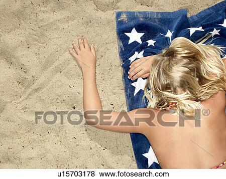 Girl on towel at the beach View Large Photo Image Stock Photo - Girl on towel at the beach. Fotosearch