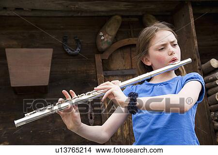 Picture - Girl playing the flute.. Fotosearch