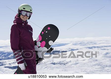 Stock Image - Girl posing with snowboard.. Fotosearch