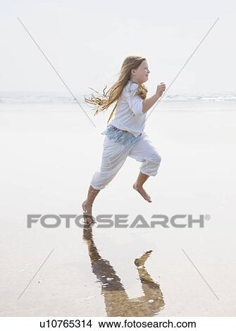 Girl running on beach View Large Photo Image Picture - Girl running on beach. Fotosearch