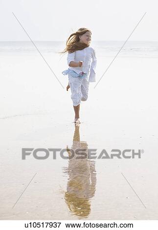 Stock Photo - Girl running on beach. Fotosearch