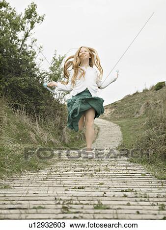 Girl skipping towards camera View Large Photo Image Stock Image - Girl skipping towards camera. Fotosearch