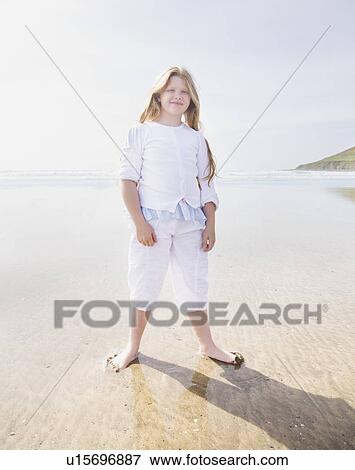 Girl standing on beach View Large Photo Image Stock Photo - Girl standing on beach. Fotosearch