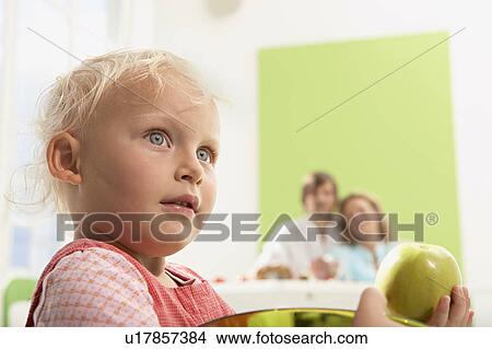 girl with green apple View Large Photo Image Picture - girl with green apple. Fotosearch
