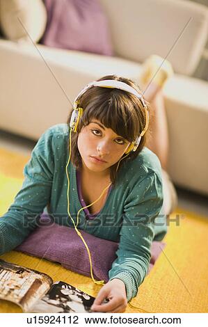 Girl with headphones and magazine View Large Photo Image Stock Image - Girl with headphones and magazine. Fotosearch