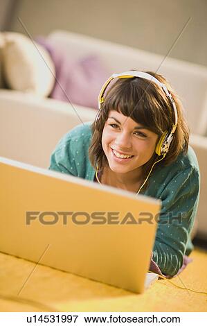 Girl with headphones and notebook View Large Photo Image Stock Photo - Girl with headphones and notebook. Fotosearch