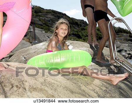 Girl with inflatable ring View Large Photo Image Picture - Girl with inflatable ring. Fotosearch