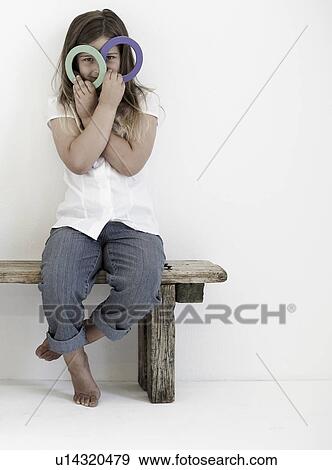 Stock Photo - Girl with toy rings smiling to camera. Fotosearch