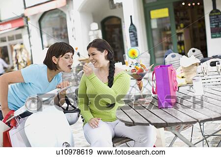 Stock Photo - girlfriends enjoying icecream. Fotosearch
