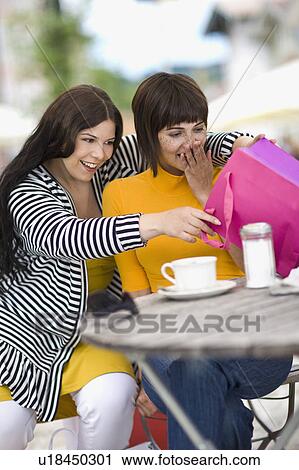 Stock Image - Girlfriends make a shopping break. Fotosearch