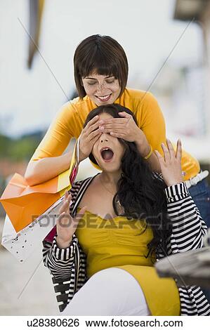 Stock Photograph - girlfriends meet at a street cafe. Fotosearch