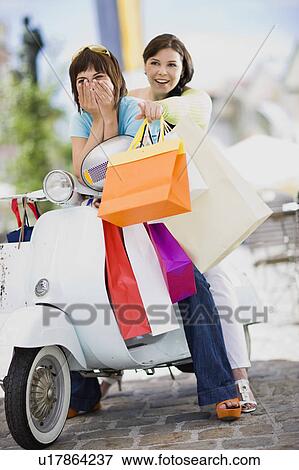 girlfriends with motor scooter View Large Photo Image Stock Photo - girlfriends with motor scooter. Fotosearch