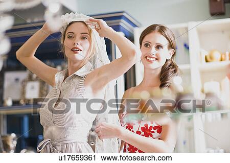 Stock Image - girls having shopping fun. Fotosearch