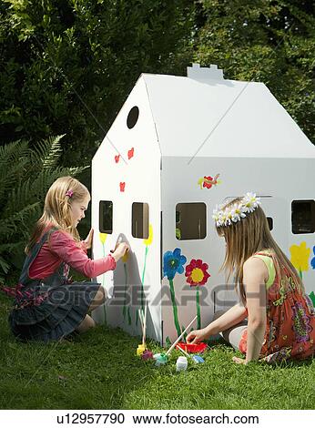 Girls painting a cardboard wendy house View Large Photo Image Stock Image - Girls painting a cardboard wendy house. Fotosearch