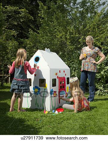 Girls painting a cardboard wendy house View Large Photo Image Stock Photo - Girls painting a cardboard wendy house. Fotosearch