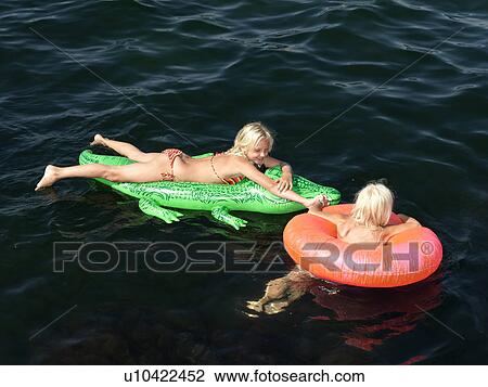 Girls playing in water View Large Photo Image Stock Image - Girls playing in water. Fotosearch