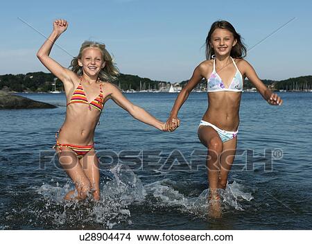 Girls running in water View Large Photo Image Picture - Girls running in water. Fotosearch