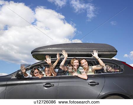 Stock Photograph - girls waving out of car windows. Fotosearch