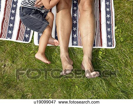 Stock Photo - Grandfather and boy on blanket. Fotosearch