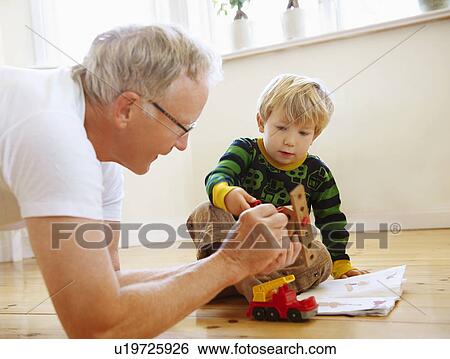 Stock Photograph - Grandfather playing with grandson. Fotosearch
