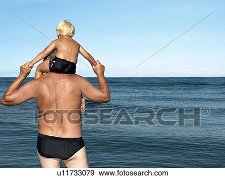 Grandfather with boy on shoulders View Large Photo Image Stock Photo - Grandfather with boy on shoulders. Fotosearch