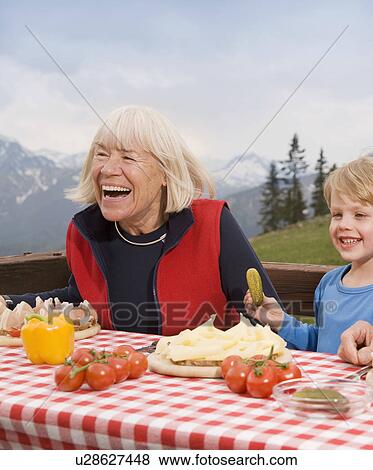 grandmother, grandson eating in mountain View Large Photo Image Stock Photo - grandmother, grandson eating in mountain. Fotosearch