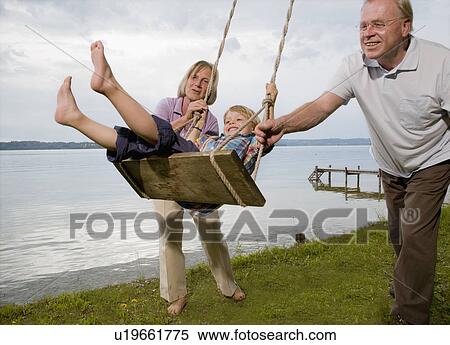grandparents with grandson on swing View Large Photo Image Stock Photography - grandparents with grandson on swing. Fotosearch