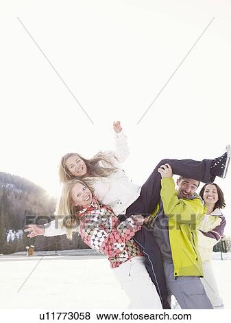 Stock Photo - group of friends playing in the snow. Fotosearch