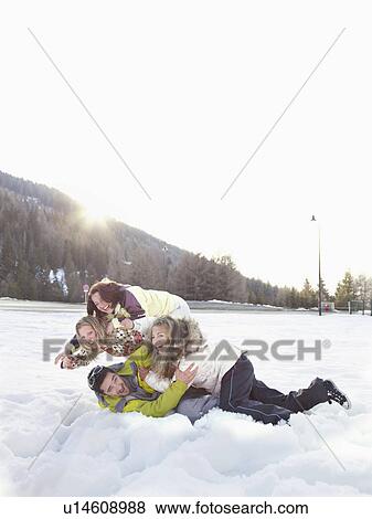 Stock Photo - group of friends playing in the snow. Fotosearch
