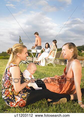 Stock Image - group of young people at barbecue. Fotosearch