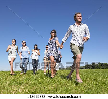 group of young people running in field View Large Photo Image Stock Image - group of young people running in field. Fotosearch