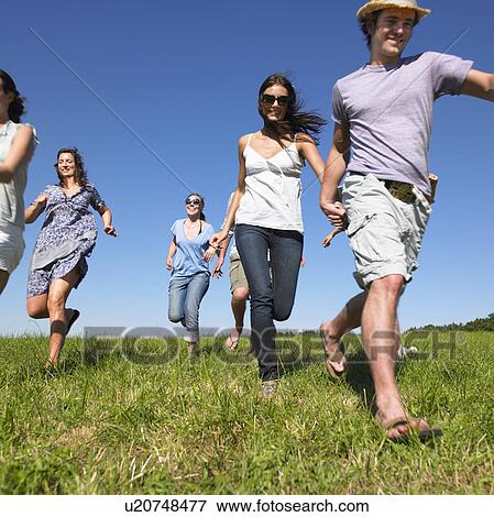 group of young people running in field View Large Photo Image Stock Photo - group of young people running in field. Fotosearch