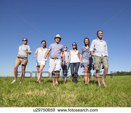 group of young people walking in field View Large Photo Image Stock Photo - group of young people walking in field. Fotosearch