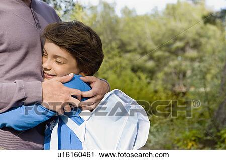 happy boy hugging dad back from school View Large Photo Image Stock Image - happy boy hugging dad back from school. Fotosearch