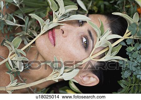 Picture - Headshot of a female with plants. Fotosearch