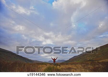 Stock Photograph - Hiker in a valley. Fotosearch