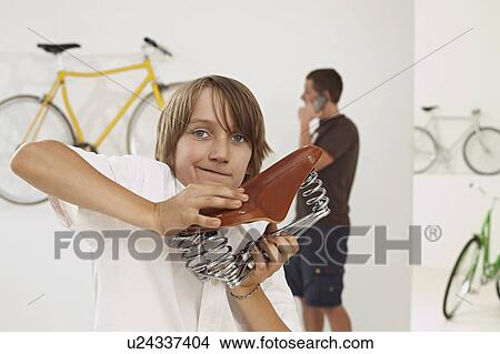 joung boy testing saddle View Large Photo Image Picture - joung boy testing saddle. Fotosearch