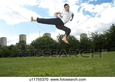 jumping kick in park View Large Photo Image Stock Image - jumping kick in park. Fotosearch
