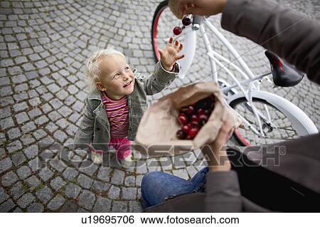 Stock Photograph - Little girl wants to have cherries. Fotosearch