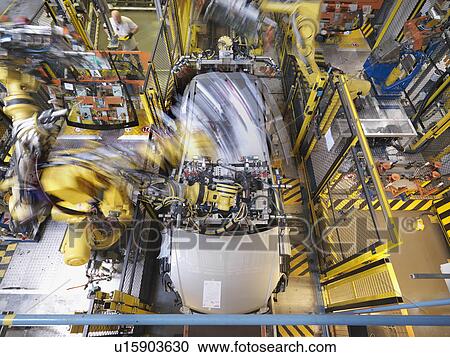 Stock Image - Machine Working On Car In Plant. Fotosearch