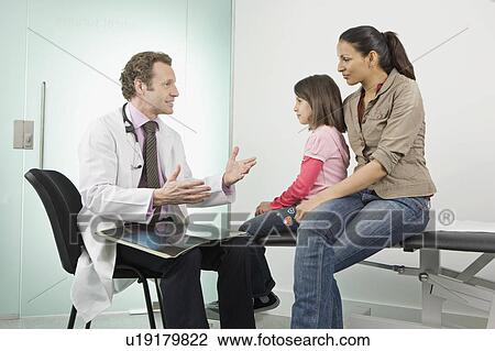 Stock Image - Male doctor checks a patients hand. Fotosearch