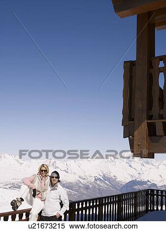 Stock Photography - man and woman at mountain top bar. Fotosearch