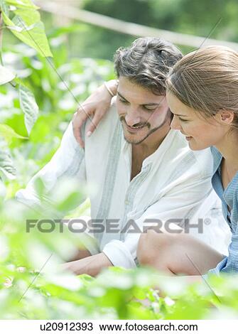 Man and woman gardening in greenhouse View Large Photo Image Stock Image - Man and woman gardening in greenhouse. Fotosearch