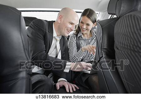 man and woman in car with laptop View Large Photo Image Stock Image - man and woman in car with laptop. Fotosearch